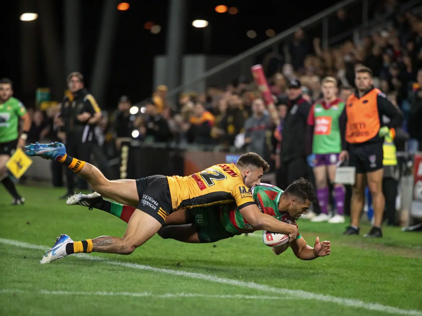 A photograph of teenage players engaged in a competitive rugby match, demonstrating their skills and teamwork. The image captures the intensity and excitement of the game.